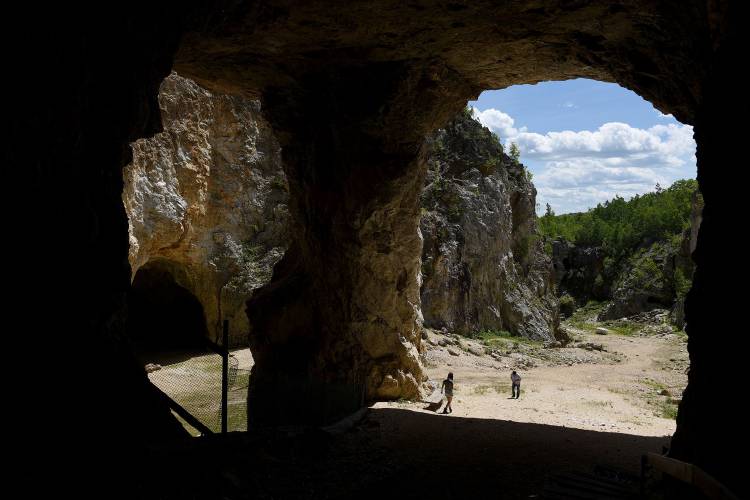 Joseph Su and his daughter Anwen, of Nashua, N.H., look around Ruggles Mine in Grafton, N.H., on June 15, 2016. They had come to the mine not knowing it was closed.
