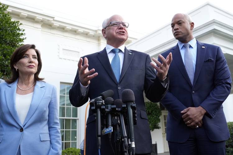 FILE - Minnesota Gov. Tim Walz, center, standing with New York Gov. Kathy Hochul, left, and Maryland Gov. Wes Moore, right, talks with reporters following their meeting with President Joe Biden at the White House in Washington, July 3, 2024. (AP Photo/Susan Walsh, File)