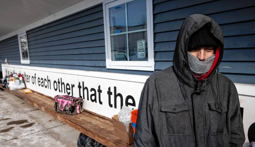 Timothy Russell tries to keep warm in front of the winter shelter in back of the Concord Homeless Resource Center on Tuesday, January 21, 2025.