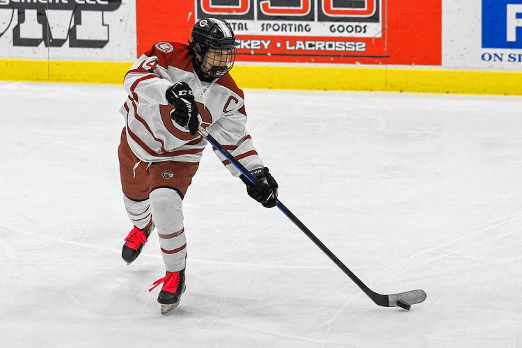 Concord defenseman Tyler Fennelly (14) looks to fire the puck to a teammate during a game against Bow at Everett Arena on Wednesday. Concord won 5-0.