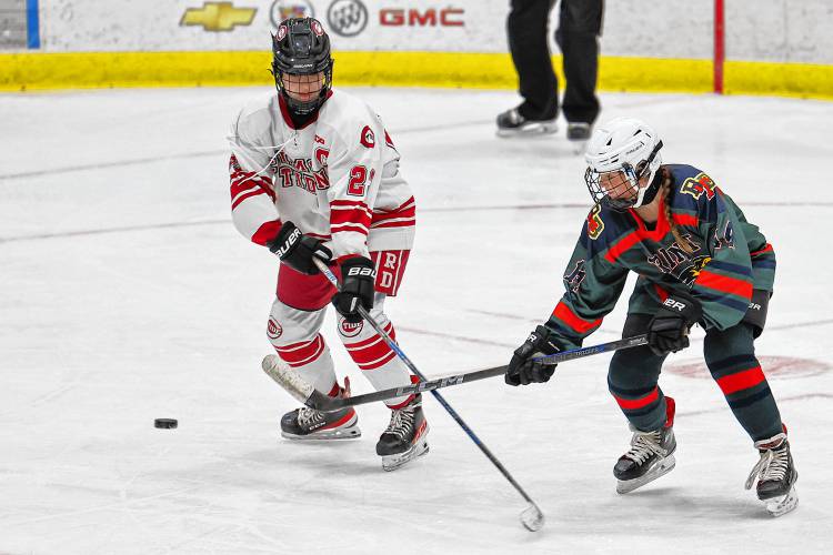 Concord junior forward Elliana Wing (22) battles for the puck with Brinity-Bow’s Kaylee Jacques (14).