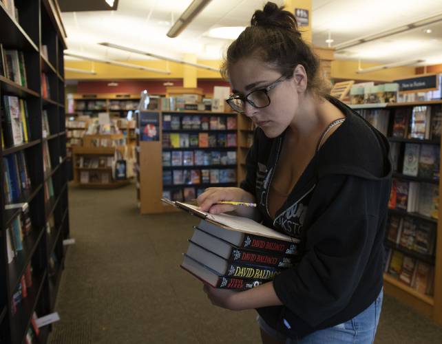 Samantha White, an employee of Gibson's Bookstore in Concord, shelves books in the store. The owner, Michael Herrmann, was in favor the redesign though the construction phase was difficult. He feels it revitalized the Main street.
