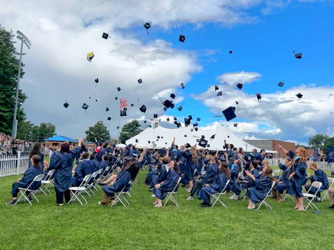 Merrimack Valley High School seniors throw their caps in the air after graduating on June 8, 2024.