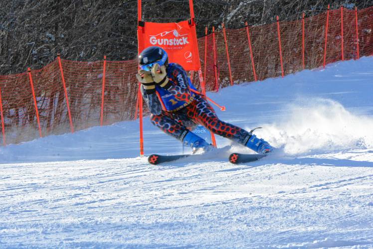 Kearsarge senior Alex Spinney carves his way down the giant slalom course at Gunstock on Tuesday at the NHIAA Division III boys’ Alpine skiing championship. Spinney finished fifth in the GS and seventh in the slalom, qualifying for the Meet of Champions in both events and leading Kearsarge to the title.