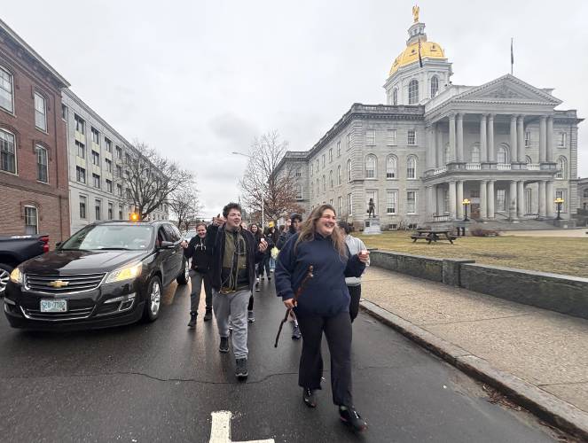 Jyanna Brideau, the niece of Rodney Moody, led the parade past the State House on Saturday, March 30, 2025. Moody passed away at the Concord Coalition to End Homelessnessâs winter shelter on February 23rd. Following the service, a group walked in procession from Centerpoint Church on North State Street to the shelter in honor of Moody.