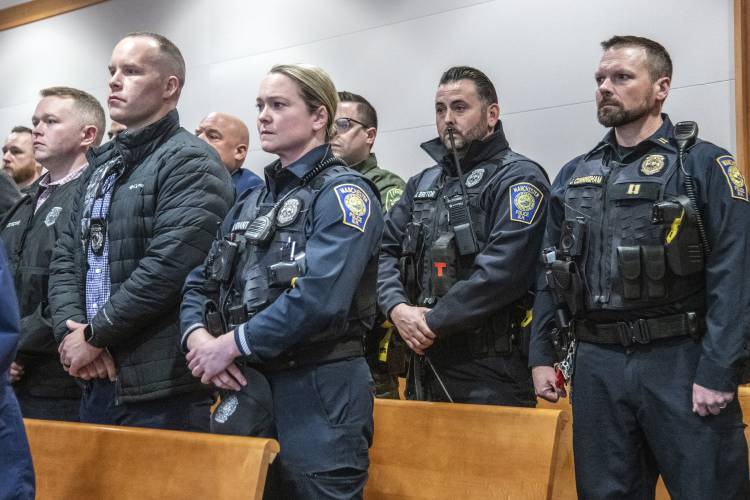 A large group of Manchester Police Officers stand in Hillsborough County Superior Court during Adam Montgomery's trial, Thursday, Feb. 22, 2024, in Manchester, N.H. Adam Montgomery has been convicted of second-degree murder in the death of his 5-year-old daughter. Police believe Harmony Montgomery was killed nearly two years before she was reported missing in 2021. (Jeffrey Hastings/Pool Photo via AP).
