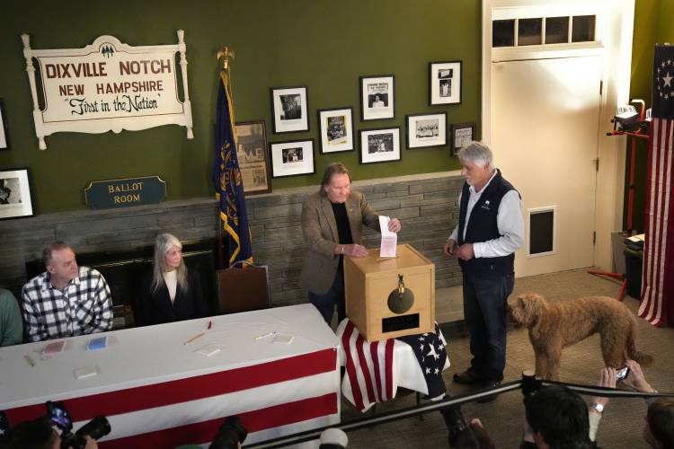 A vote is inserted into the ballot box by town moderator Tom Tillotson shortly after midnight in the presidential primary election, Tuesday, Jan. 23, in Dixville Notch. A vote is inserted into the ballot box by town moderator Tom Tillotson shortly after midnight in the presidential primary election, Tuesday, Jan. 23, in Dixville Notch.