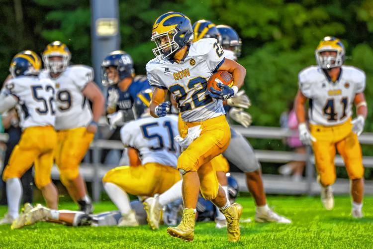Bow running back Miles Miller (22) breaks away from the line during Friday night’s game at Merrimack Valley. Miller scored a 5-yard touchdown run, had a big catch and made many tackles on defense to help secure Bow’s 23-13 victory.
