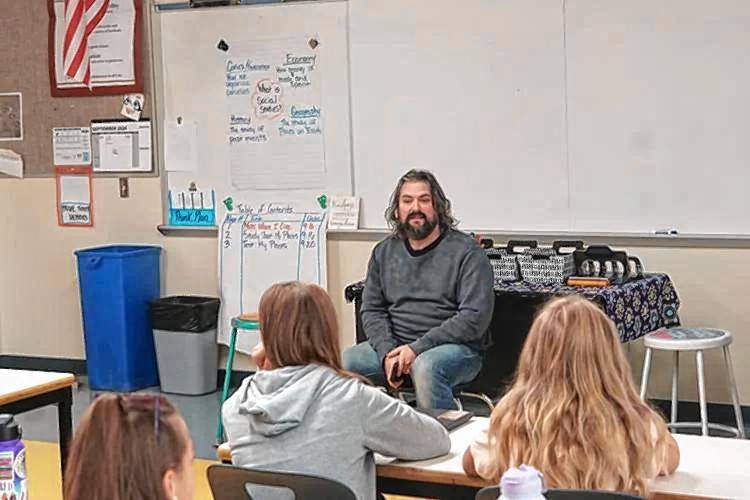 Musician Clay Cook of the Zac Brown Band speaks to a music class at Laconia Middle School on Tuesday morning. Musician Clay Cook of the Zac Brown Band speaks to a music class at Laconia Middle School on Tuesday morning.