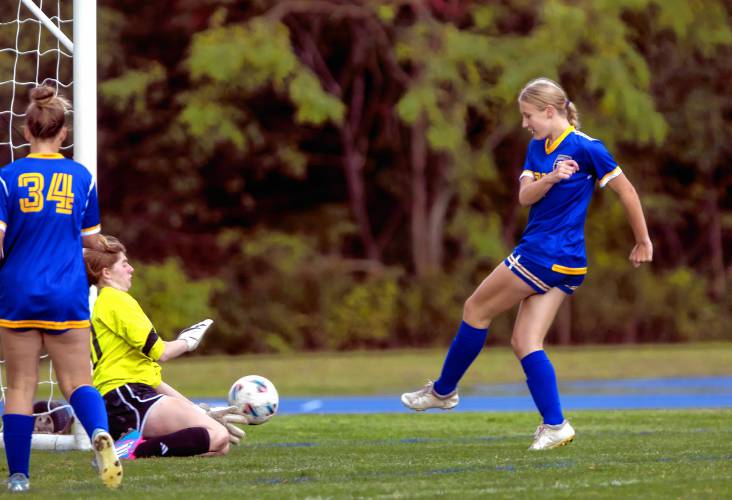 Kearsarge forward Katie Walkinshaw shoots against Hillsboro-Deering goalie Alexis LaPorte.
