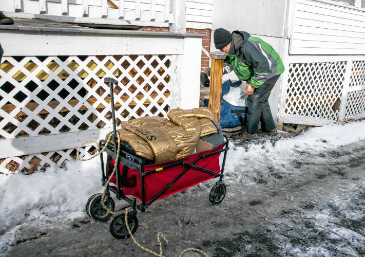 Raymond Blodgett re-packs some of his belongings at the Homeless Resource Center North Main Street in Concord on Tuesday, January 21, 2025. Blodgett was looking for his brother to help him replace a broken tire on his wagon.