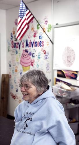 Suzy Seagroves stands in front of “Suzy’s wall” in her classroom at Bishop Brady class on February 19, 2025.
