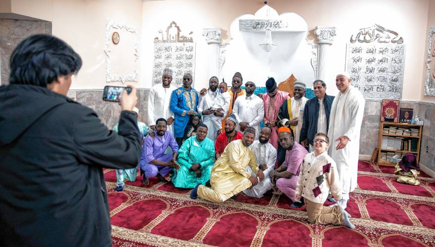 The men and boys get their photo taken after the Eid al-Fitr service at IQRA Islamic Society of Greater Concord on Wednesday, April 10, 2024. The service celebrates the end of the holy month of Ramadan in the Muslim calendar.