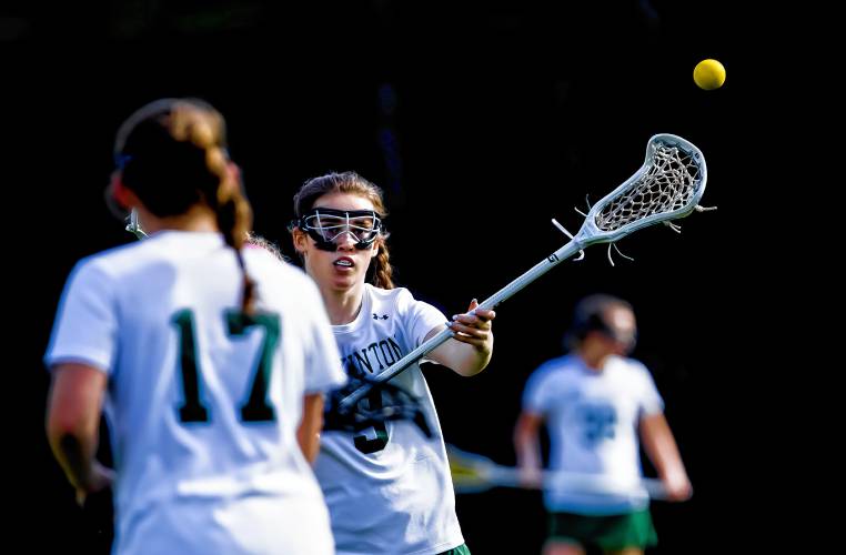 Hopkinton lacrosse player Maeve Owens (9) brings up the ball with her teammates against Bishop Brady on Friday, May 3.