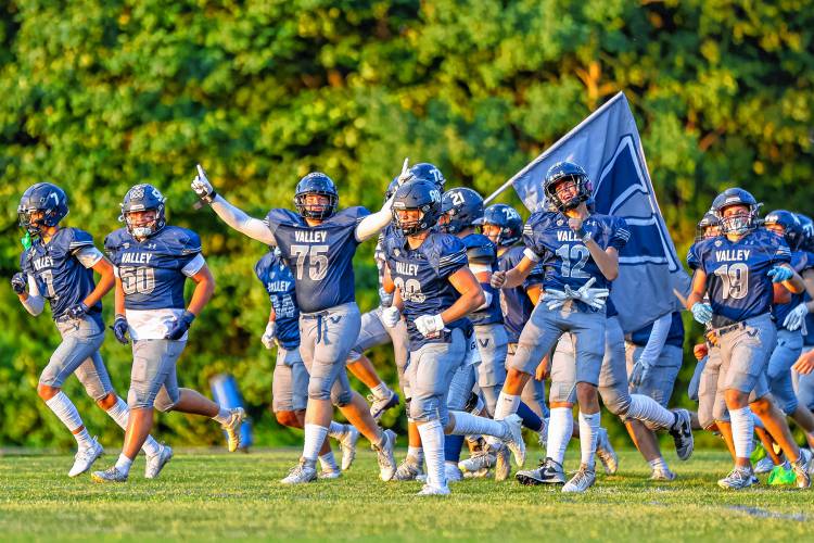 Merrimack Valley’s varsity football team runs onto the field prior to kickoff in Friday night’s home opener. MV fought hard, but lost 23-13.