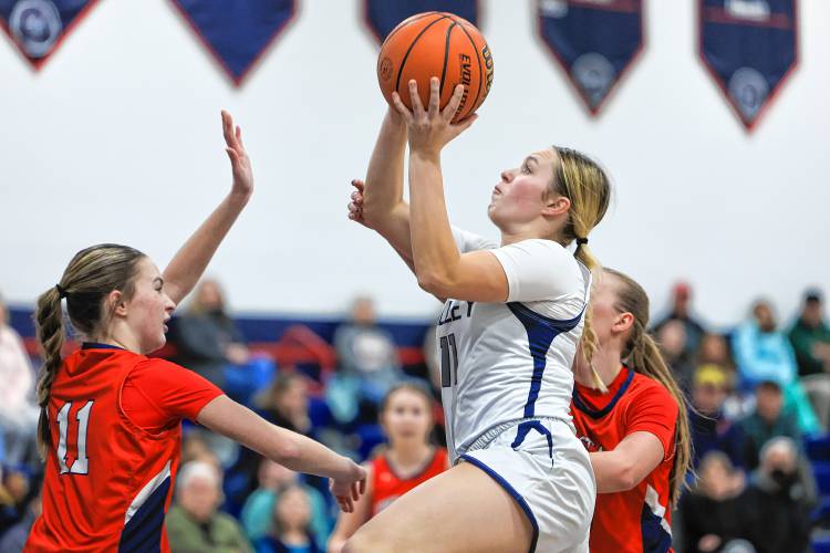 Merrimack Valley’s Kayla Smith (right) goes up for a shot over John Stark’s Jillian Fredette (left) in the opening round of the Capital Classic Holiday Basketball Tournament on Friday at MVHS. Smith recorded 20 points and nine rebounds in the victory, helping the Pride advance to Monday’s championship game against Bow.