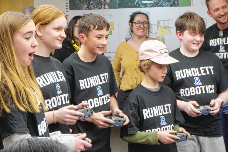 Members of the robotics club at Rundlett Middle School demonstrated their creations to the school board at the outset of its meeting Monday night. The group meets after school and worked to build their robots and code them to complete specific tasks. The club is run through the district's 21st Century Community Learning Centers afterschool program. 
