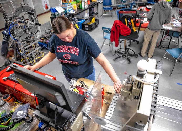 Concord High School senior Laura Lorenze works on making an updated bracket for the team robot on the CNC drill machine on Wednesday, February 26, 2025. The team has a competition match this Saturday.