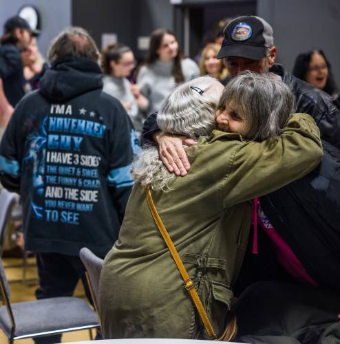 Bonnie Mae Whittmore (left) and Barbara Locke hug at the memorial service for Rodney Moody.
