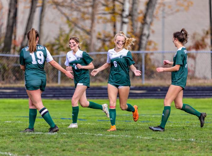 Pembroke Academy’s Bailey Gatchell (6) celebrates with teammates after scoring the first goal of the game in the third minute of a 6-1 win over No. 10 Pelham in a D-II girls’ soccer first-round playoff game on Oct. 25. Gatchell scored four goals in the contest.