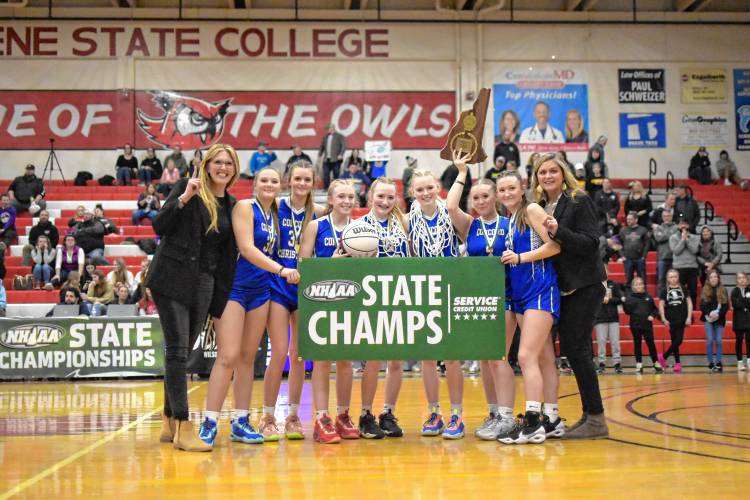 The Concord Christian girls’ basketball team poses with the championship plaque after winning the Division III title on Feb. 25 at Keene State College’s Spaulding Gymnasium. After winning the D-IV title in 2022 and the championship in their inaugural D-III season last year, the Lady Kingsmen look to continue their streak in D-II.