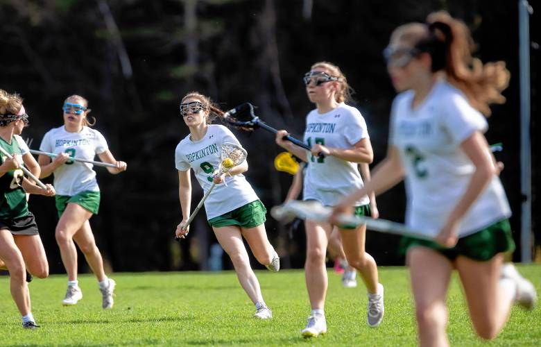 Hopkinton lacrosse players Maeve Owens (9) brings up the ball with her teammates against Bishop Brady on Friday, May 3.