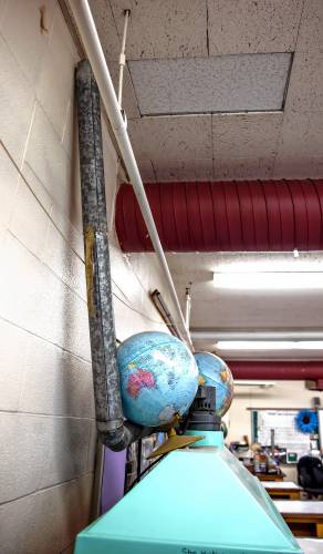 The pipe that fell in Amy Schaeffner’s classroom still sits near two globes in the front of her class.