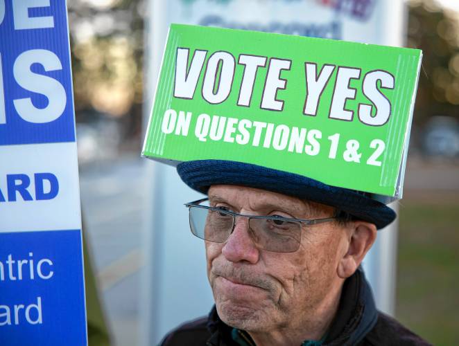 Robert Maccini wears a Vote Yes headpiece for the proposed charter amendments on the Concord ballot in front of the Ward Nine polling place on Tuesday, November 5, 2024.  The petitioned amendment needed a 
60% majority required to pass.