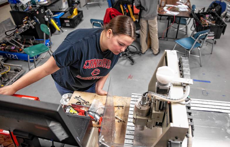 Concord High School senior Laura Lorenze works on making an updated bracket for the team robot on the CNC drill machine on Wednesday, February 26, 2025. The team has a competition match this Saturday.