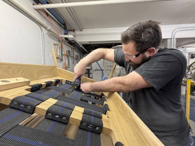 Built by Newport furniture company employee Eric Benware puts webbing on a sofa after the business's owner Dave Laforce, who sources material from Canada, attended a roundtable event with U.S. Sen. Peter Welch of Vermont and Marie-Claude Bibeau, a Canadian member of parliament, to discuss the Trump administration's tariffs, Tuesday, March 18, 2025, in Newport, Vt. (AP Photo/Amanda Swinhart) Built by Newport furniture company employee Eric Benware puts webbing on a sofa after the business's owner Dave Laforce, who sources material from Canada, attended a roundtable event with U.S. Sen. Peter Welch of Vermont and Marie-Claude Bibeau, a Canadian member of parliament, to discuss the Trump administration's tariffs, Tuesday, March 18, 2025, in Newport, Vt. (AP Photo/Amanda Swinhart)
