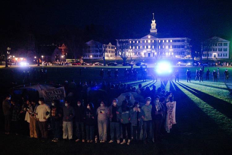 New Hampshire State Police, and Lebanon and Hanover Police cross the Dartmouth College Green to remove students protesting the Israel-Hamas War in Hanover, N.H., on Wednesday.