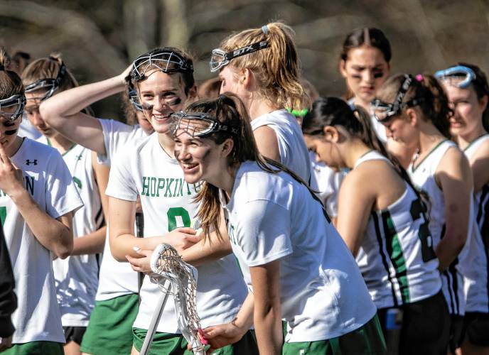 Hopkinton girls’ lacrosse players Maeve Owens (9) and Lilly Chodosh share a laugh during halftime against Bishop Brady on May 3.