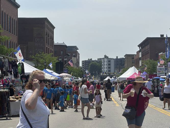 Visitors take part in the annual Market Days street fair in Concord, N.H., on Thursday morning, June 20, 2024, with temperatures in the 90s. A heat wave extending from the Midwest to New England moved closer to a breaking point Thursday, with millions of people sweating it out for another day. (AP Photo/Kathy McCormack)
