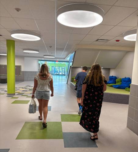 Eighth grade students Morgan, Brielle, and Grady walk through the hallways of Allenstown Community School.