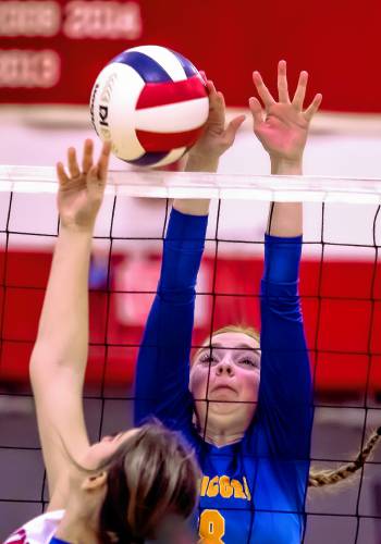 Concord Christian player Evelyn Doan blocks a shot during the Division III semifinal match at Laconia High School on Thursday. The Kingsmen swept Trinity, 3-0, and are heading to Saturday’s finals.