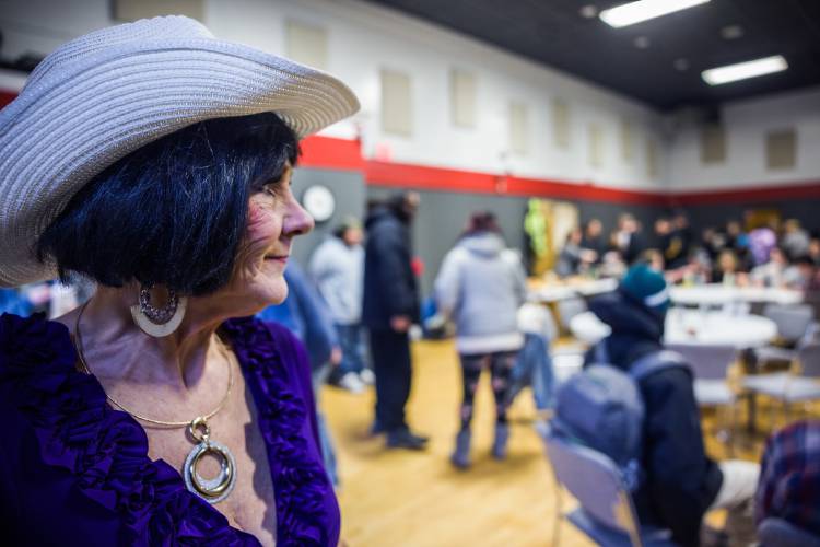 Deborah Eckland looks out at the crowd at the memorial service for Rodney Moody,  that brought out friends and part of the unhoused community on Saturday, March 30, 2025.  Moody died at the Concord Coalition to End Homelessnessâs winter shelter on February 23rd. After the service, a group walked in a procession from CenterPoint Church on North State over to the shelter in honor of Moody.