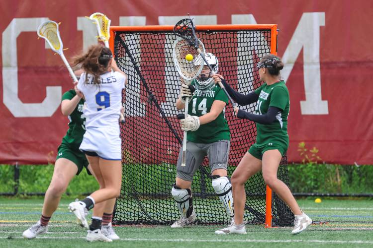Senior goalie Grace Hodgdon (14) was forced to make multiple one-on-one saves against Gilford, and despite allowing 18 goals, played with focus until the final whistle.