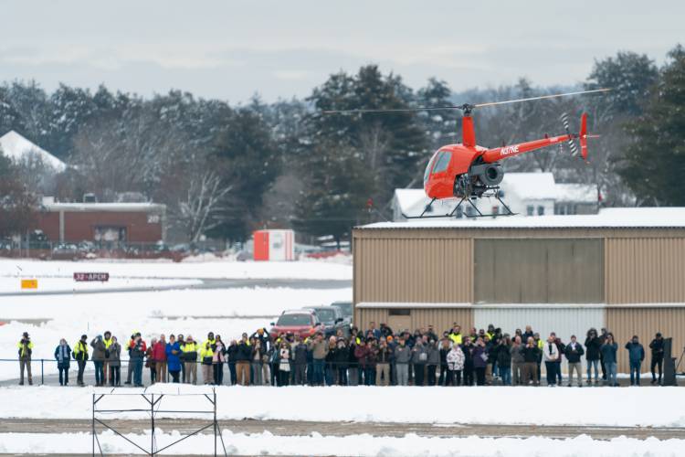 Rotor’s R220Y, an uncrewed R&D aircraft based on the Robinson R22 2-seat helicopter, takes flight without anyone onboard for the first public test flight at the Nashua Airport while assembled guests look on.