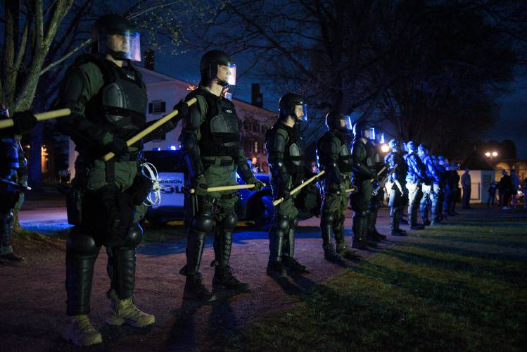 New Hampshire State Police wearing riot gear gather before crossing Dartmouth College Green to remove protesters who set up tents to protest the Israel-Hamas War in Hanover, N.H., on Wednesday.