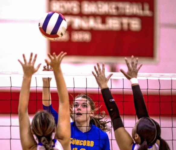 Concord Christian hitter Sadie Thompson pushes the ball over two Trinity players during the Division III semifinal match at Laconia High School on Thursday. The Kingsmen swept Trinity and are heading to the finals on Saturday.