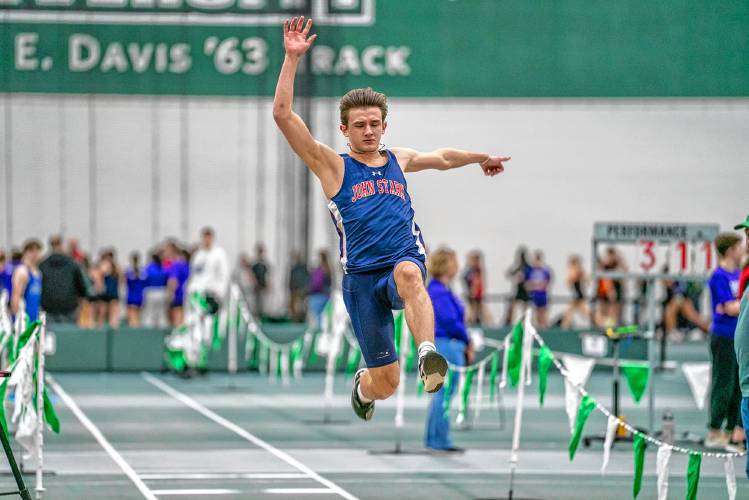 John Stark’s Rio Calle takes flight in the long jump at an indoor track meet on Saturday at Plymouth State. Calle won both the long jump and the high jump.