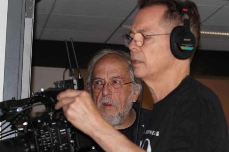 Rick Broussard, left, and John Hession in Red River Theater as they set up to film a final  scene of the movie “Granite Orpheus.”
