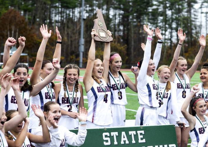 The John Stark field hockey team celebrates their back-to-back championship on Sunday, Oct. 29, 2023, at Bedford High School after beating Kennett High School, 1-0. 