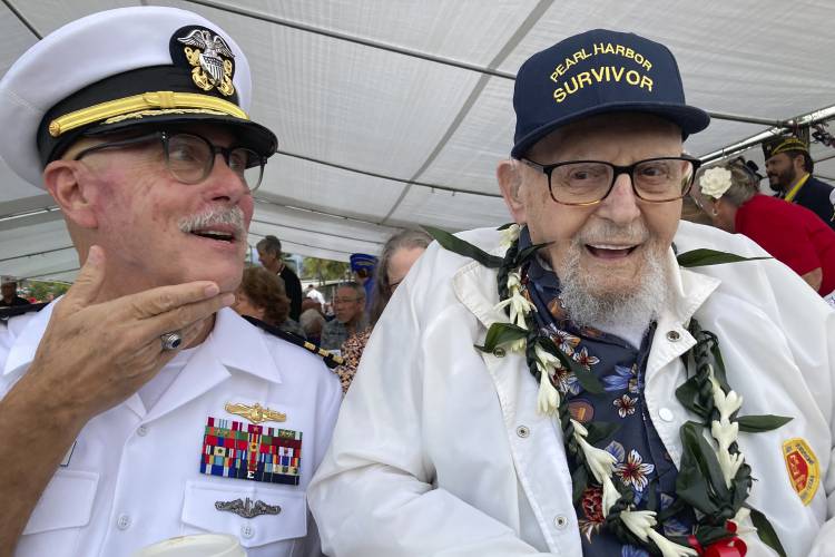 FILE - Ira Schab, right, who survived the attack on Pearl Harbor as a sailor on the USS Dobbin, talks with reporters while sitting next to his son, retired Navy Cmdr. Karl Schab, on Dec. 7, 2022, in Pearl Harbor, Hawaii. Eighty-two years later, Schab plans to return to Pearl Harbor on the anniversary of the attack to remember the more than 2,300 servicemen killed. He's expected to be one of just six survivors at the ceremony commemorating the event that propelled the United States...