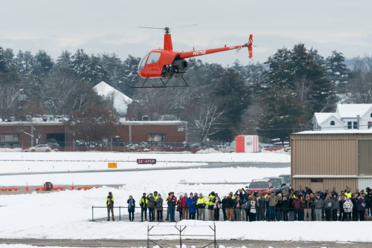 Rotor’s R220Y, an uncrewed R&D aircraft based on the Robinson R22 2-seat helicopter, takes flight without anyone onboard for the first public test flight at the Nashua Airport while assembled guests look on.