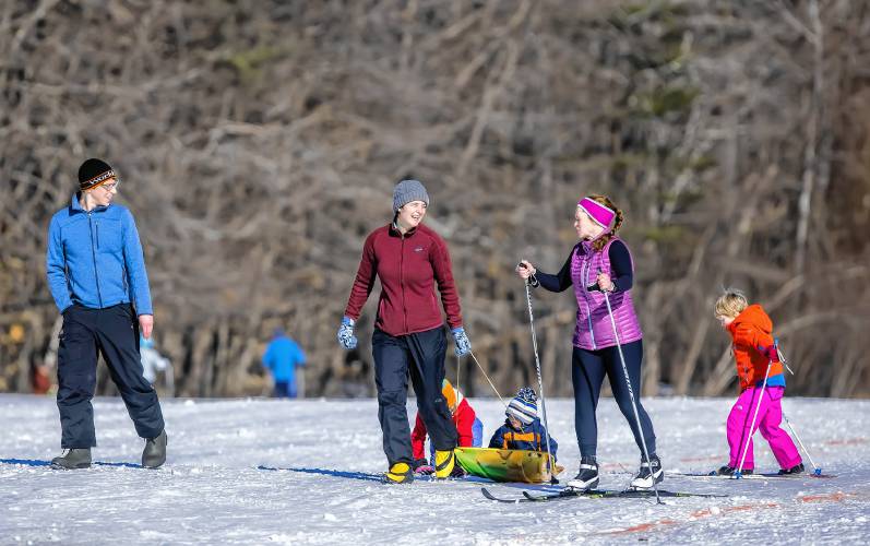 From left: Reed Loy watches as Linden Rayton pulls her children while skiing with Rachel Edes and Julian Loy. They were finishing up their cross country trek at The Concord Community Nordic Trails at Beaver Meadow Golf Course after the Ski the Beav 5K and Learn to Ski on Sunday. This event paired a low-key freestyle community race with a free Learn-to-Ski clinic at the course afterward.