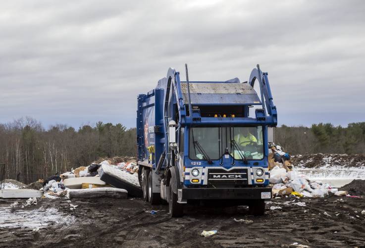 A refuse truck backs up to dump trash at the Nashua landfill.