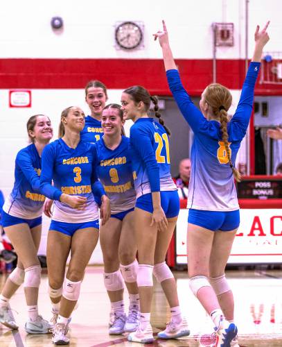 Concord Christian players celebrate a winning point during the Division III semifinal match at Laconia High School on Thursday. The Kingsmen swept Trinity and are heading to the finals on Saturday.