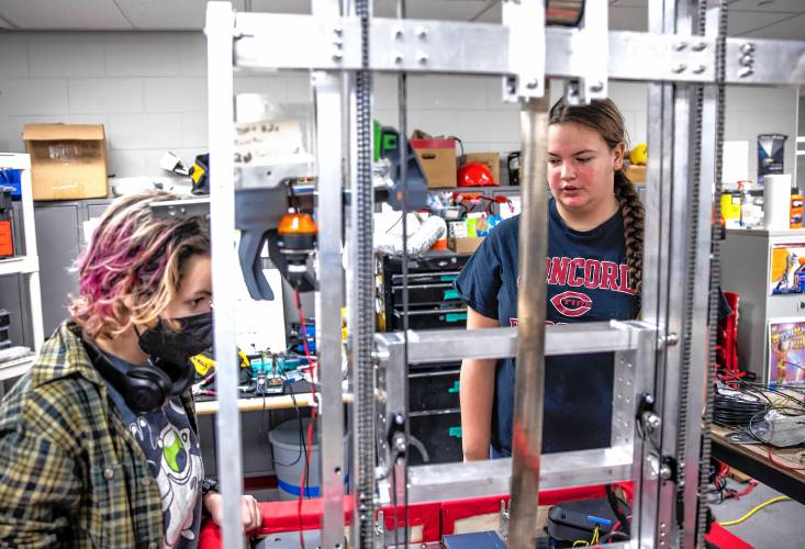 Concord High School senior Laura Lorenze (right) and Tidal Force junior Veronica Galdieri works on making an updated bracket for the team robot on Wednesday, February 26, 2025. The team has a competition match this Saturday.