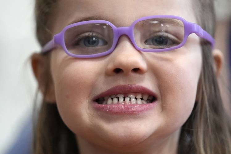 Amber Warner shows off her teeth after a dental exam at the Christa McAuliffe School in Concord, N.H., Wednesday, Feb. 21, 2024. The federal government and the dental community are increasing efforts to reach children at an early age. (AP Photo/Robert F. Bukaty) 